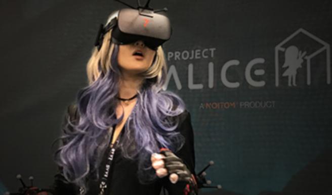 A Japanese influencer wears goggles at the Alice Space virtual reality experience by Noitom at SVVR 2017.